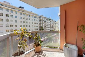 an apartment balcony with a view of a building at Suite Sainte-Hélène FSHH in Nice