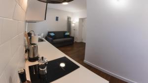 a kitchen with a counter and a couch in a room at Casa Frino in Ghiffa +10 photos