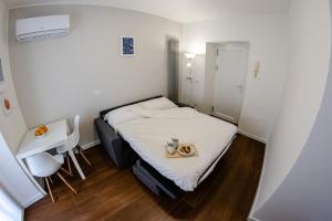 a small room with a bed with a tray on it at Casa Frino in Ghiffa