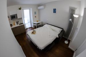 a small bedroom with a bed and a table at Casa Frino in Ghiffa