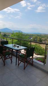 a table and chairs on a balcony with a view at Vana's Apartments in Sarandë