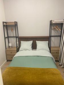 a bedroom with a large bed with a yellow blanket at Lou Occitan- Appartement cosy centre Béziers in Béziers