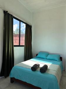 a bedroom with a bed and a window at Casa roja Depto A in Palenque