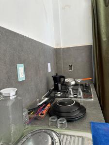 a kitchen counter with a stove with a pot on it at Casa roja Depto A in Palenque
