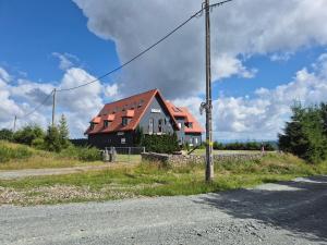 a house with a red roof on the side of a road at ORLIK House in Duszniki Zdrój +9 photos