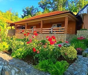 a house with flowers in front of it at Vila Vera Borsko Jezero in Bor