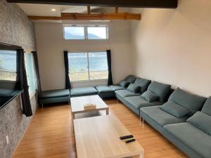 a living room with a couch and a table at Koya TRIBE - Vacation STAY 48392v in Oishi