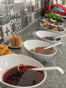 a counter with bowls of soup and bowls of food at Ürgüp Elit Otel in Ürgüp