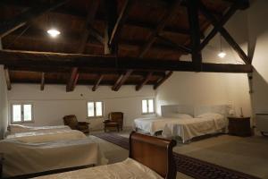a bedroom with two beds in a room with wooden ceilings at Villa Trigatti in Galleriano +38 photos