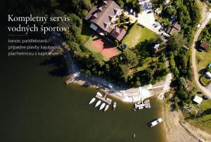 an aerial view of a house in the water at Penzion Kormoran in Námestovo