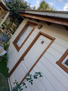 a white front door of a house at Hostal y Cabañas Guaje in Valdivia
