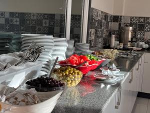 a kitchen with plates and bowls of fruit on a counter at Ürgüp Elit Otel in Ürgüp
