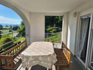 a table and chairs on a balcony with a view at Studio apartman Tilia in Veliko Trgovišće