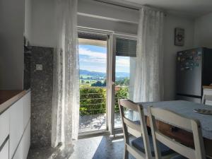 a dining room with a table and a glass door at Studio apartman Tilia in Veliko Trgovišće