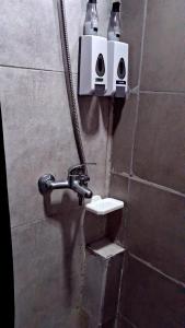 a bathroom with a toilet and two lights on the wall at Che Lolita house 4 in Buenos Aires
