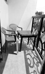 two chairs and a table on a balcony at Rift Valley in Bulenga