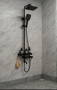 a shower in a bathroom with a shower head at Rift Valley in Bulenga