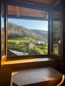 a window with a view of a mountain view at Lar da cima in Folgoso