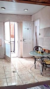 a living room with a table and a door at Che Lolita house 4 in Buenos Aires