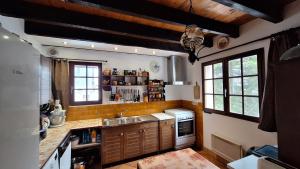 a kitchen with a sink and a stove at Beau chalet en vallée d'Ossau in Laruns