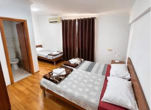 a bedroom with two beds and a bathroom at Rooms Ava Raj in Međugorje