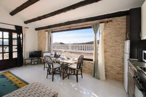a dining room with a table and a large window at Clara Suite 3 - Macaronesiahomes in Conil