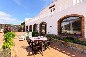 a patio with a table and chairs outside of a building at Clara Suite 1 - Macaronesiahomes in Conil
