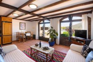 a living room with a couch and a tv at Clara Suite 1 - Macaronesiahomes in Conil