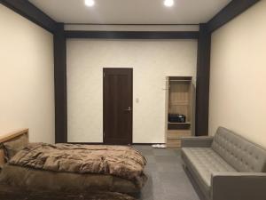 a bedroom with a bed and a couch at Iitoko - Vacation STAY 43906v in Iitoyo +9 photos