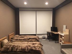 a bedroom with a bed and a desk with a computer at Iitoko - Vacation STAY 43906v in Iitoyo