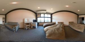 a room with two beds and a desk in it at Iitoko - Vacation STAY 43906v in Iitoyo