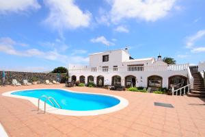 a large white house with a swimming pool in front of it at Clara Suite 2 - Macaronesiahomes in Masdache