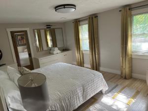 a bedroom with a bed with a table and a mirror at Pigeon's Roost on Rushmore in Rapid City
