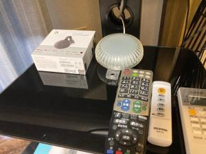 two remote controls and a box on a table at ARASHIMA INN 203 / Vacation STAY 230 in Toba