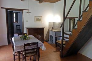 a dining room with a table and a fireplace at Loggia dei Barbaggianni in Torraca