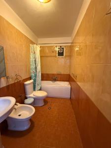 a bathroom with two toilets and a tub and a sink at Tirana Panorama in Tirana +20 photos