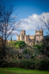 a castle sitting on top of a hill at Le Cocon Vouté, air-conditioned in Saint-Laurent-des-Arbres