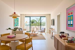 a living room with a table and chairs at Kimpton Los Monteros Marbella by IHG in Marbella