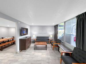 a waiting room with a couch and a table at Celebration Suites in Orlando