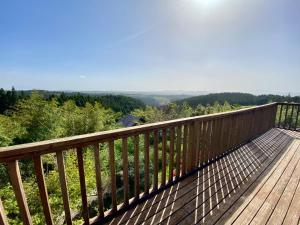 a wooden deck with a view of the mountains at DeepSpot - Vacation STAY 19274v in Minamioguni