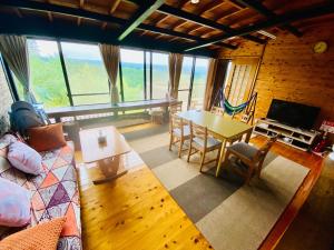 a living room with a couch and a table and chairs at DeepSpot - Vacation STAY 19274v in Minamioguni