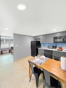 a large kitchen with a wooden table and chairs at Celebration Suites in Orlando