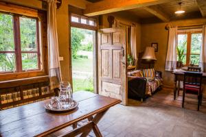 a living room with a wooden table and a couch at Siódmy Las in Zawada