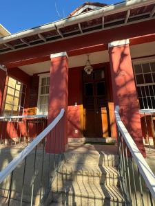 a house with a front porch with a door at HMG Morada & Chalet - Centro histórico in Petrópolis