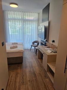 a room with a bed and a desk with a computer at Zasavski Gurman in Dol pri Hrastniku +34 photos