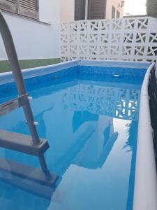 a swimming pool with blue water in a house at Llar Montagut in Torredembarra