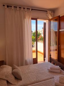 a bedroom with a bed and a large window at Llar Montagut in Torredembarra +68 photos