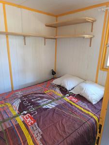 a bed in a room with two bunk beds at Camping du lac chalet P62 in Foix