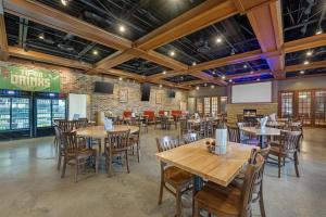 a dining room with wooden tables and chairs at Best Western Plus Dubuque Hotel and Conference Center in Dubuque