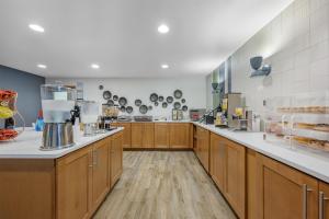 a large kitchen with wooden cabinets and a counter at Best Western Plus Dubuque Hotel and Conference Center in Dubuque